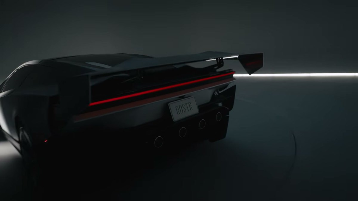Parte trasera del Tesla Roadster con el alerón levantado y la luz trasera roja de lado a lado